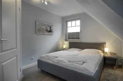 Ein Bett oder Betten in einem Zimmer der Unterkunft Dat suutsche Huus