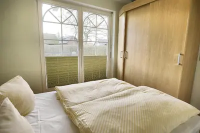 Ein Bett oder Betten in einem Zimmer der Unterkunft Villa Vogelsang, FW 2