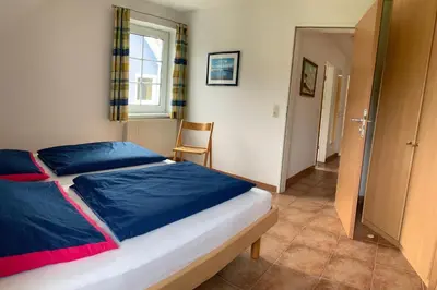 Ein Bett oder Betten in einem Zimmer der Unterkunft Ostseehaus 1