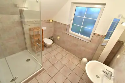 Ein Badezimmer in der Unterkunft Haus Marleen OG, FW 2