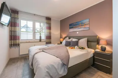Ein Bett oder Betten in einem Zimmer der Unterkunft Birkenstraße 6 Haus II Whg1