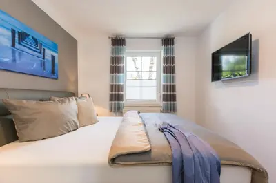 Ein Bett oder Betten in einem Zimmer der Unterkunft Birkenstraße 6 Haus II Whg3