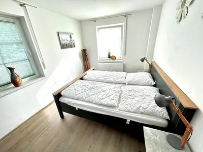Ein Bett oder Betten in einem Zimmer der Unterkunft Birkenstraße 7 Whg 1