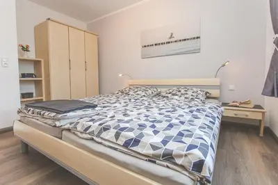 Ein Bett oder Betten in einem Zimmer der Unterkunft Birkenperle Wohnung 5