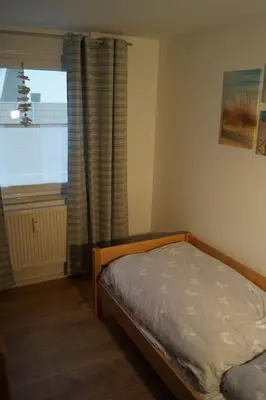 Ein Bett oder Betten in einem Zimmer der Unterkunft Zum Strandkorb