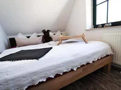 Ein Bett oder Betten in einem Zimmer der Unterkunft de lütte Kabuff