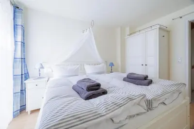 Ein Bett oder Betten in einem Zimmer der Unterkunft Haus Möwe