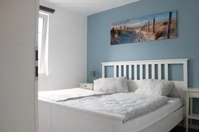 Ein Bett oder Betten in einem Zimmer der Unterkunft Ferienwohnung Ocean in Born