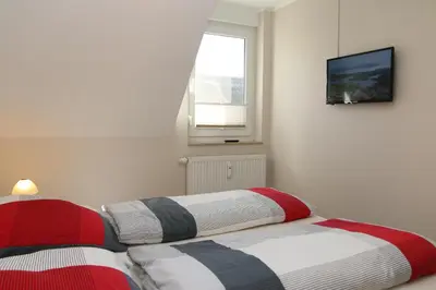 Ein Bett oder Betten in einem Zimmer der Unterkunft Ferienwohnung Strandaster