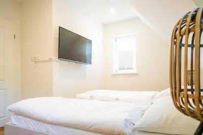 Ein Bett oder Betten in einem Zimmer der Unterkunft Traumgarten - Haus Abendsonne