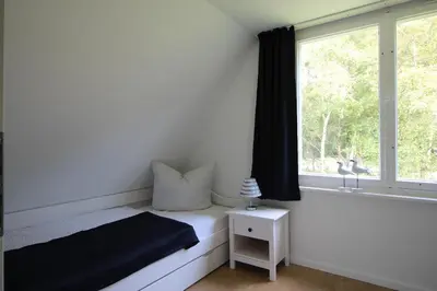 Ein Bett oder Betten in einem Zimmer der Unterkunft Reethaus Ostseestrand 15