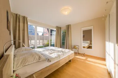 Ein Bett oder Betten in einem Zimmer der Unterkunft DIE LODGE Ferienwohnung in Zingst