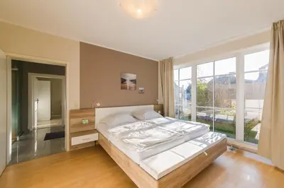 Ein Bett oder Betten in einem Zimmer der Unterkunft DIE LODGE Ferienwohnung in Zingst
