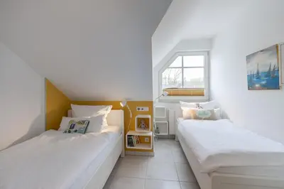 Ein Bett oder Betten in einem Zimmer der Unterkunft Am Horizont No 1 für 2-4 Pers, 2 Schlafz, Babybett, Südbalkon, kostenloser Parkplatz, 500 Meter zum Strand