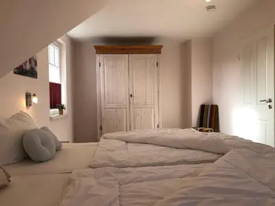 Ein Bett oder Betten in einem Zimmer der Unterkunft Friedenstrasse Haus Kranich
