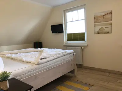 Ein Bett oder Betten in einem Zimmer der Unterkunft Friedenstrasse Haus Kranich