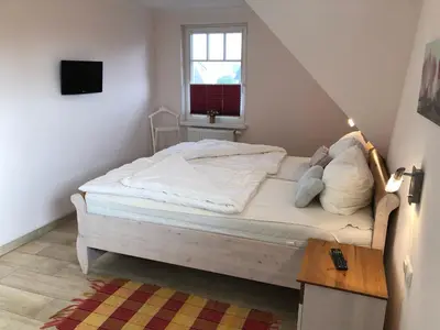 Ein Bett oder Betten in einem Zimmer der Unterkunft Friedenstrasse Haus Kranich