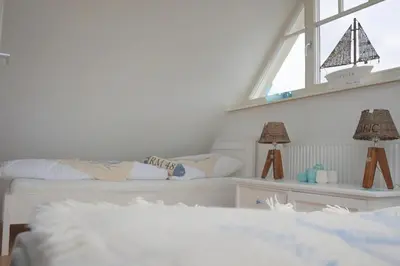 Ein Bett oder Betten in einem Zimmer der Unterkunft Kavelweg Haus JENNY
