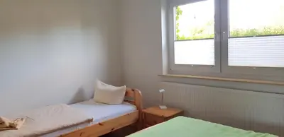 Ein Bett oder Betten in einem Zimmer der Unterkunft Alte Gärtnerei App Rhododendron
