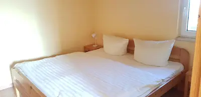 Ein Bett oder Betten in einem Zimmer der Unterkunft Alte Gärtnerei App Hortensie