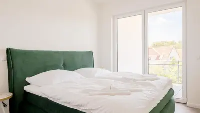 Ein Bett oder Betten in einem Zimmer der Unterkunft Apartmenthaus Wittsande - 01