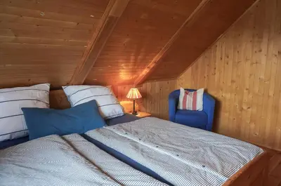 Ein Bett oder Betten in einem Zimmer der Unterkunft Birkmaase 3 Muschelblau OG