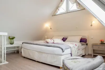 Ein Bett oder Betten in einem Zimmer der Unterkunft Ostseeperle