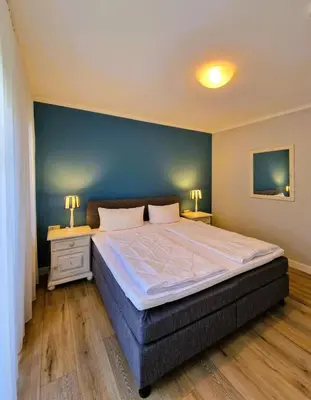 Ein Bett oder Betten in einem Zimmer der Unterkunft Darsser Weg 38