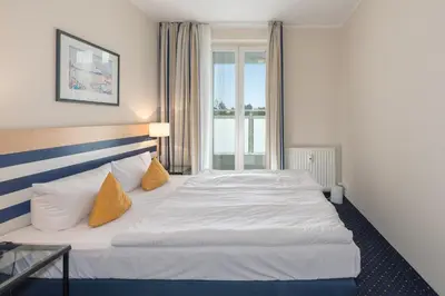 Ein Bett oder Betten in einem Zimmer der Unterkunft Apartment am Kurstrand