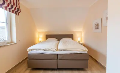 Ein Bett oder Betten in einem Zimmer der Unterkunft Seeteufel