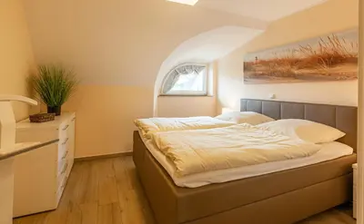 Ein Bett oder Betten in einem Zimmer der Unterkunft Seeteufel