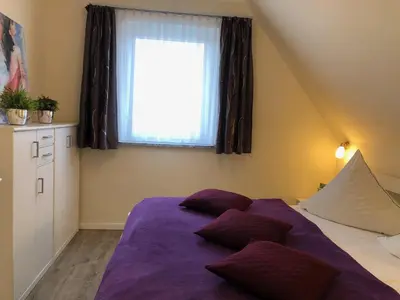 Ein Bett oder Betten in einem Zimmer der Unterkunft Gartenweg 3 Haus Maritimus 