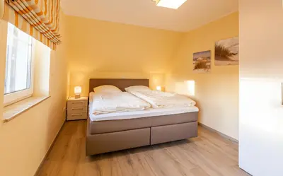 Ein Bett oder Betten in einem Zimmer der Unterkunft Seeadler