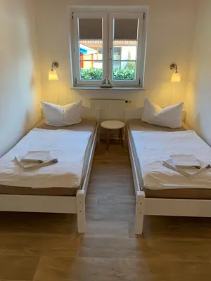 Ein Bett oder Betten in einem Zimmer der Unterkunft Pension Windrose
