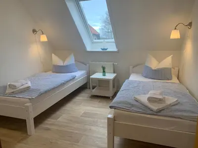 Ein Bett oder Betten in einem Zimmer der Unterkunft Pension Windrose