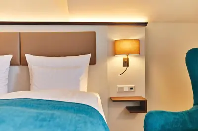 Ein Bett oder Betten in einem Zimmer der Unterkunft Dorint Strandresort & Spa Ostseebad Wustrow