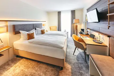 Ein Bett oder Betten in einem Zimmer der Unterkunft Dorint Strandresort & Spa Ostseebad Wustrow