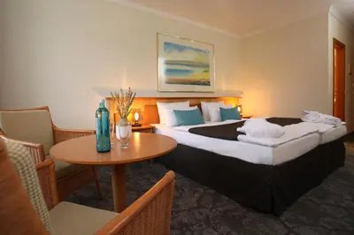 Ein Bett oder Betten in einem Zimmer der Unterkunft Hotel Bernstein Prerow