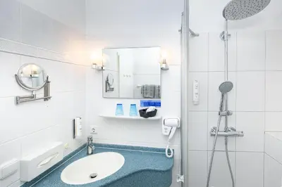 Ein Badezimmer in der Unterkunft Hotel Schlösschen Sundische Wiese Zingst