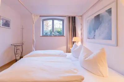 Ein Bett oder Betten in einem Zimmer der Unterkunft Dünenhof DÜNENHOF Whg. D-02