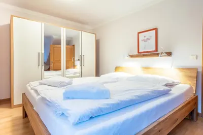 Ein Bett oder Betten in einem Zimmer der Unterkunft Dünenhof DÜNENHOF Whg. D-10