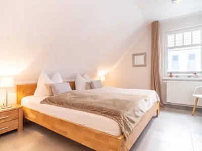 Ein Bett oder Betten in einem Zimmer der Unterkunft Haus STRANDLUST WF-04