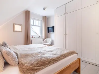 Ein Bett oder Betten in einem Zimmer der Unterkunft Haus STRANDLUST WF-04