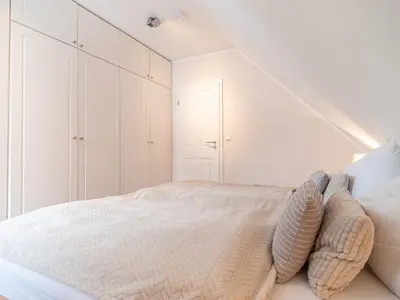 Ein Bett oder Betten in einem Zimmer der Unterkunft Haus STRANDLUST WF-04