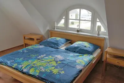 Ein Bett oder Betten in einem Zimmer der Unterkunft Ferienhaus das Blaue Haus WS-9a
