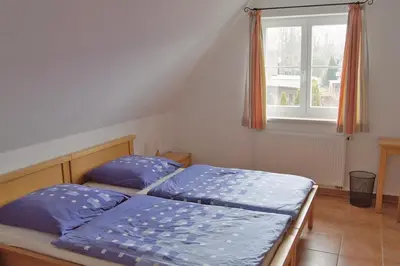 Ein Bett oder Betten in einem Zimmer der Unterkunft Ferienhaus das Blaue Haus WS-9a