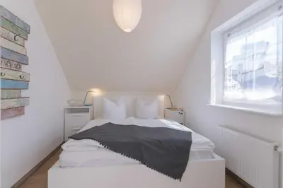 Ein Bett oder Betten in einem Zimmer der Unterkunft Born - Wieck DAT SCHWEDENHUS OG-Whg. WI-4.2