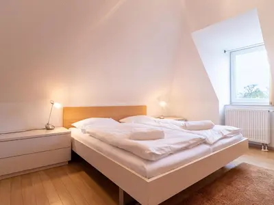 Ein Bett oder Betten in einem Zimmer der Unterkunft Grüne Straße FeWo G3 (DG links)