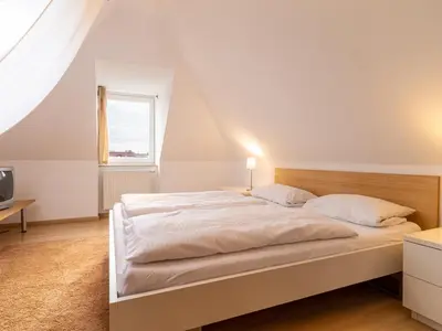 Ein Bett oder Betten in einem Zimmer der Unterkunft Grüne Straße FeWo G4 (DG rechts)