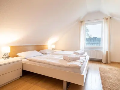 Ein Bett oder Betten in einem Zimmer der Unterkunft Grüne Straße FeWo G7 (DG links)